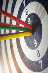 color pencils in bull's eye Success hitting target aim goal achi