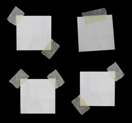 Pieces of torn paper on black. Copy space