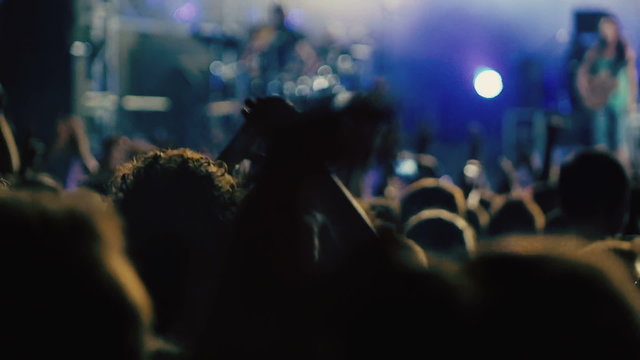 Slow motion big crowd at concert cheering clapping hands