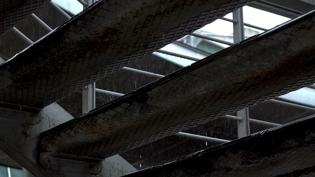 Rain dripping on steel rusty platform,ladder,slow motion