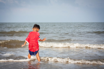 Fototapeta na wymiar little boy play at the beach