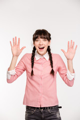 Amazed woman standing with raised hands up