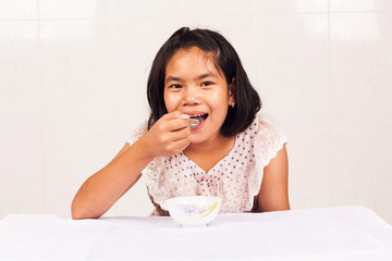 cute girl eating breakfast cereal