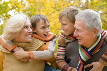 Fototapeta premium Grandparents with children in park