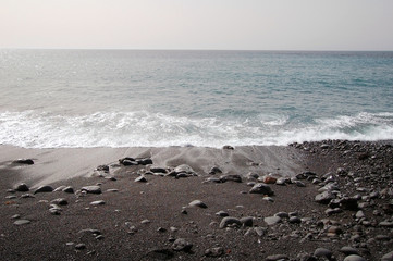 Black sand beach with volcanic stones