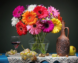 Still life with Transvaal daisies in a transparent vase.