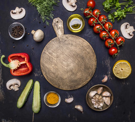 cutting board, around lie ingredients variety of vegetables and fruits, place for text,frame on wooden rustic background top view