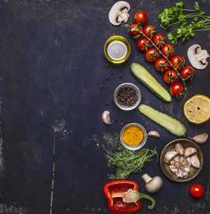 Ingredients for cooking vegetarian food tomatoes on a branch, herbs, cucumber, lemon, garlic, oil, black pepper, paprika, mushrooms, border ,with text area on wooden rustic background top view