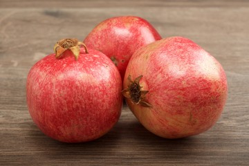 Fototapeta na wymiar Juicy pomegranate fruit on wooden background
