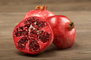 Juicy pomegranate fruit on wooden background