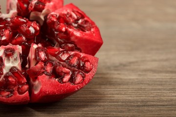 Juicy pomegranate fruit on wooden background