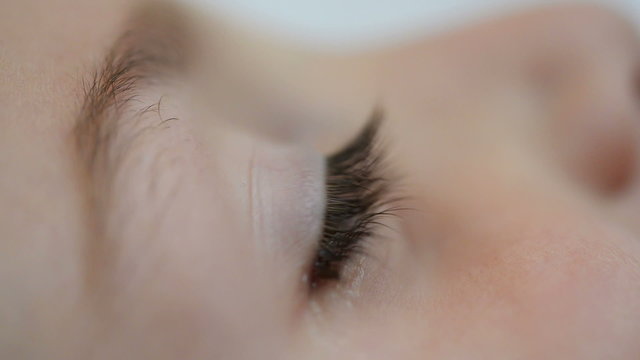 Close up of an eye of a child receiving medicine, eye drop