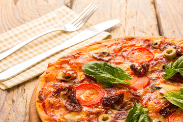 Delicious pizza served on wooden table