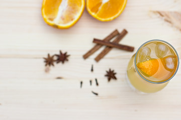 Lemonade with orange and spices on the table