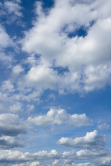 Cloudscape over horizon. Blue sky and white clouds.