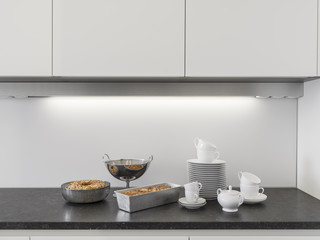 dishes and cakes  on the worktop in the modern kitchen