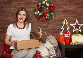 Pretty woman opening Christmas presents