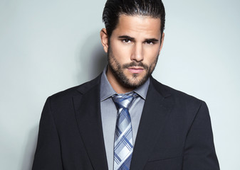 handsome young man in suit on grey background. Business man
