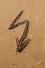 Arrow dawn drawn in the sand