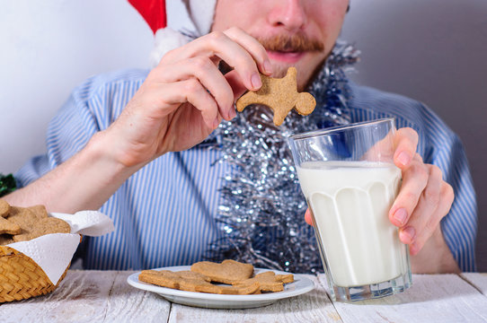 Young Man Eating Christmas Gingerbread Cookies