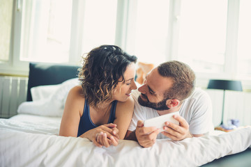 Young man and woman in bed