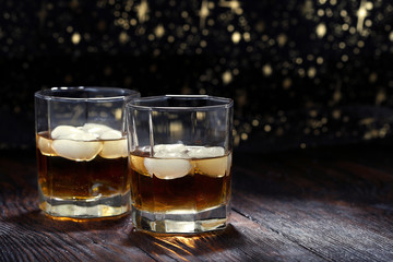Two glasses of whiskey on a old table