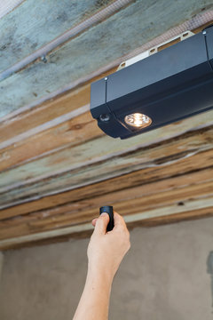 Garage doors installation. Contractor programming a mechanical garage door opener