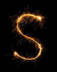Sparkler firework light alphabet S at night