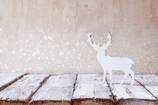 white reindeer on wooden table .selective focus