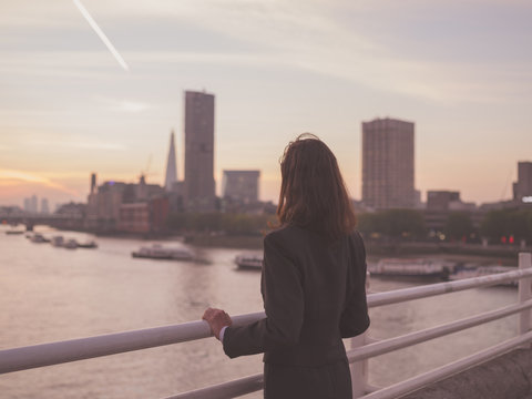 Businesswoman admiring sunrise in London