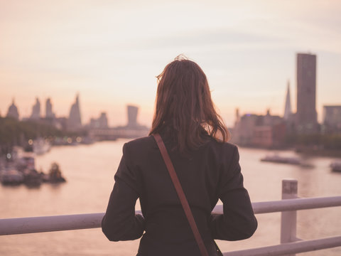 Young woman admiring London at sunrise