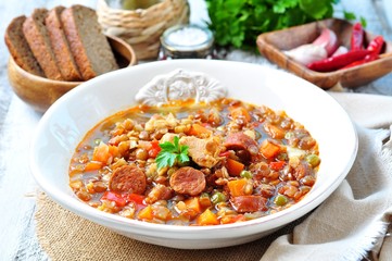 Lentil soup with chicken and pepperoni sausage, onion, carrot, sweet pepper, garlic and parsley.