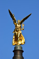 Fototapeta premium MUNICH, GERMANY - Gilded statue featuring a Peace Angel (Friedensengel) on the top of a column