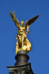 Fototapeta premium MUNICH, GERMANY - Gilded statue featuring a Peace Angel (Friedensengel) on the top of a column