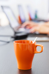 Coffee mug and notebook computer