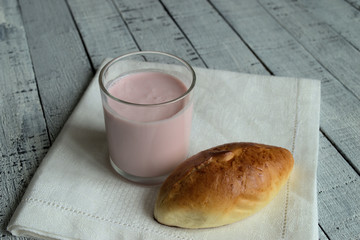 Dessert. On a wooden background linen napkin. On a napkin cup of yogurt and cake.