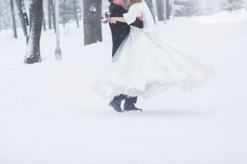bride and groom in winter frost with a snowflow
