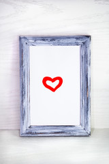 the heart is in a frame on a white background