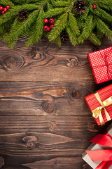 Fir tree and gift boxes on dark wooden background