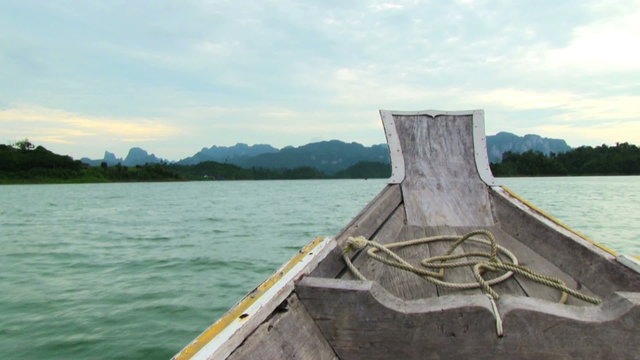 The wooden boat floating in the tropical sea