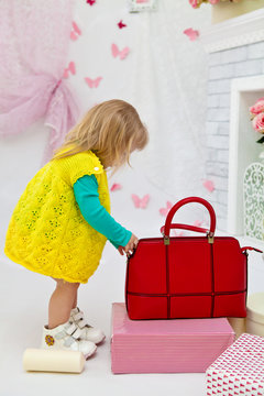 Beautiful girl with red fashion bags in the interior