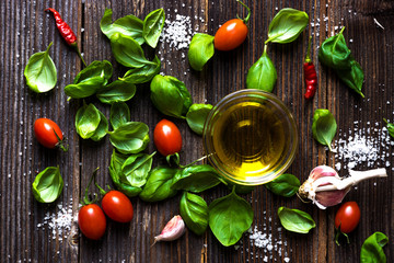 Fresh basilic leaves on a wooden table.