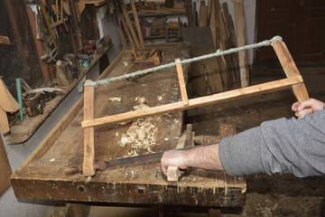carpenter working with plane on wooden
