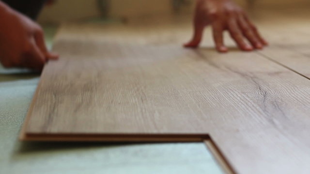 worker laying laminate