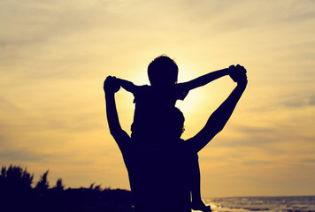 Fototapeta premium father and son having fun at sunset