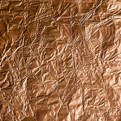 Background of crumpled foil in golden tones