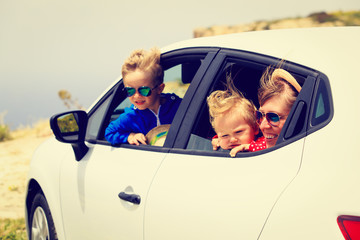 mother with son and daughter travel by car
