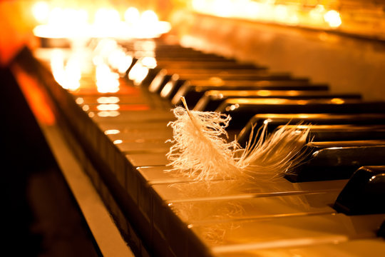 The keyboard of the piano in the golden light