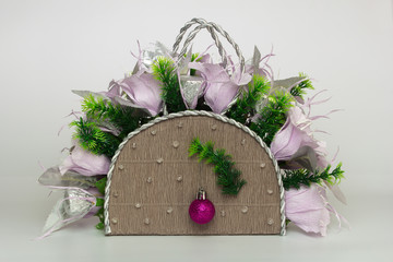 Decorative basket with paper lilies and christmas ball