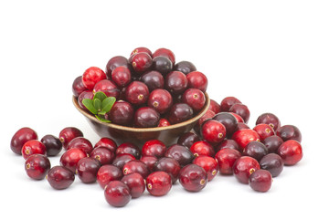 Cranberries in wooden bowl on white background